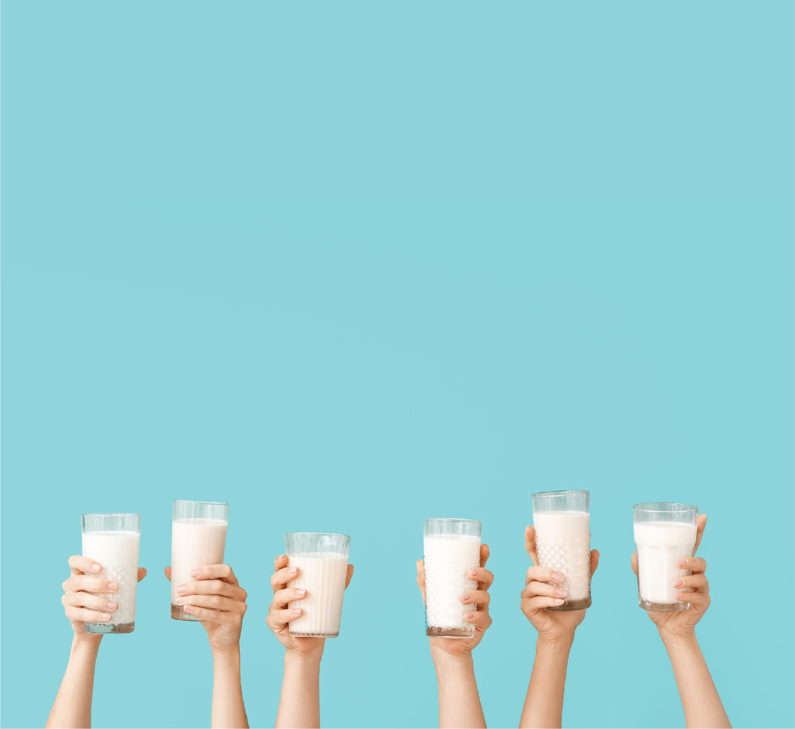 Picture of hands holding up glasses of milk